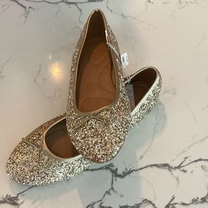 Gold sparkly flats.